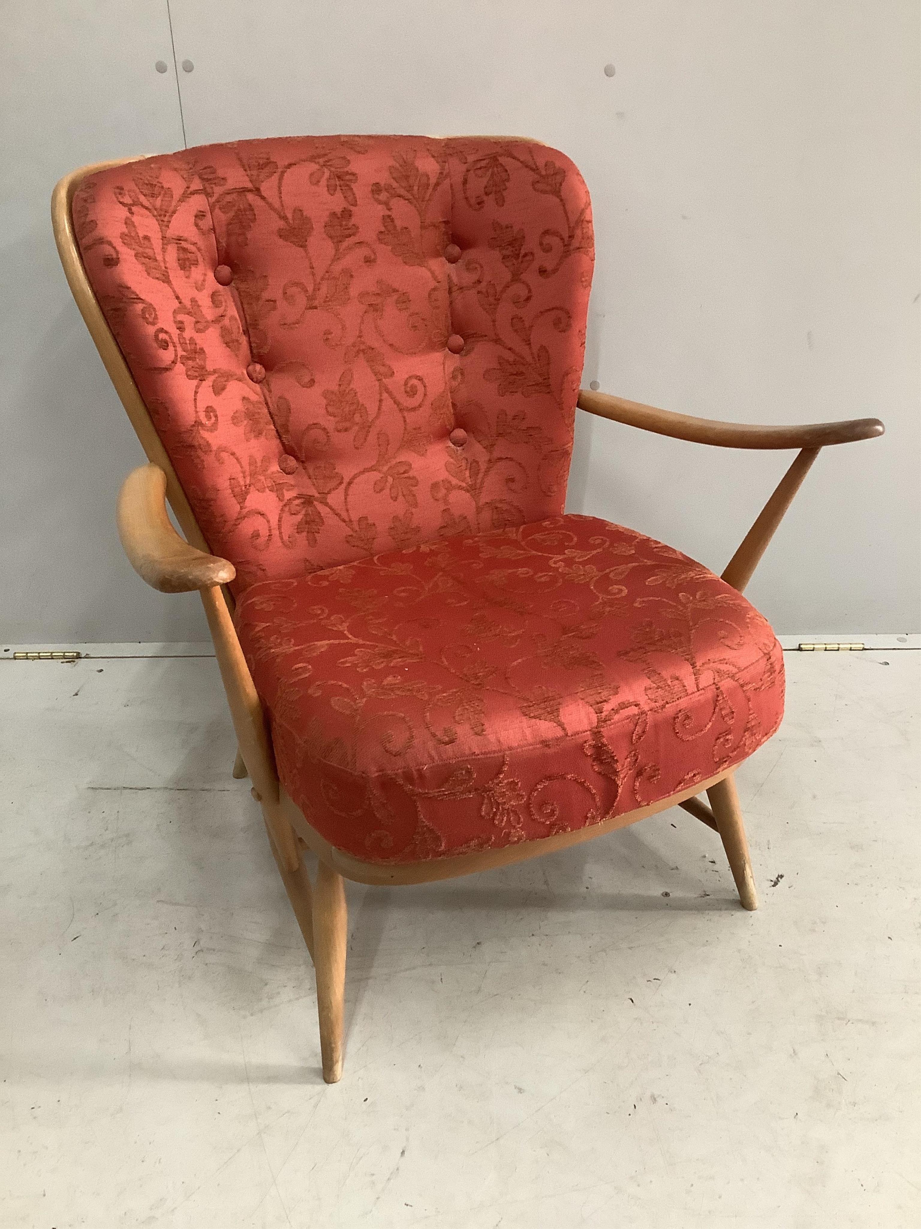 An Ercol golden beech armchair, width 73cm, height 82cm. Condition - rubbing to the tips of the arms, otherwise fair